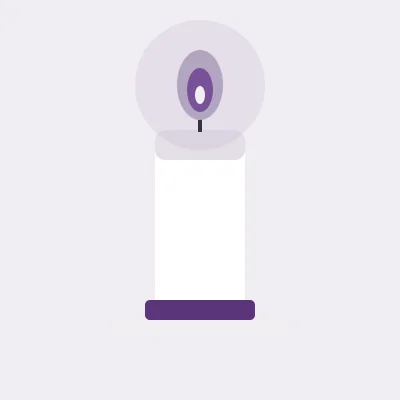 A lit candle in a low holder